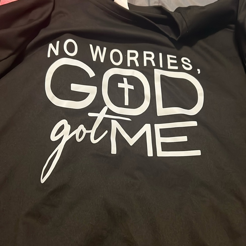 Black shirt with white letters.  Size says XXL but it fits like a Medium.